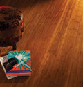 Modern Sports product packaging on a wooden floor with a patterned chair.
