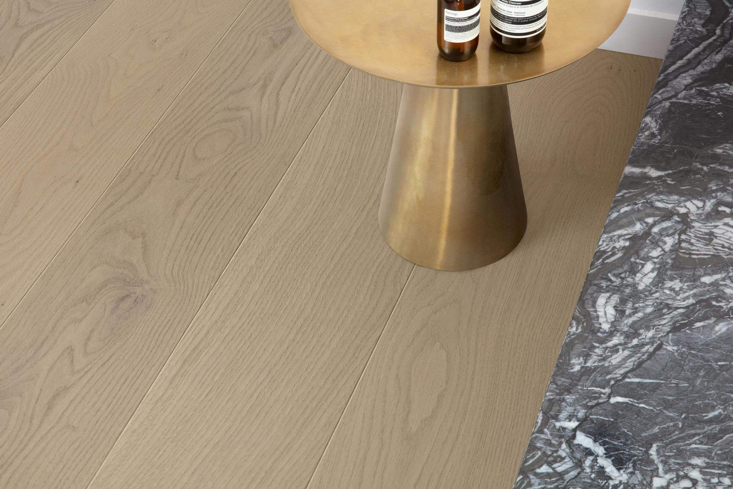 Wooden floor with a gold side table and marble surface
