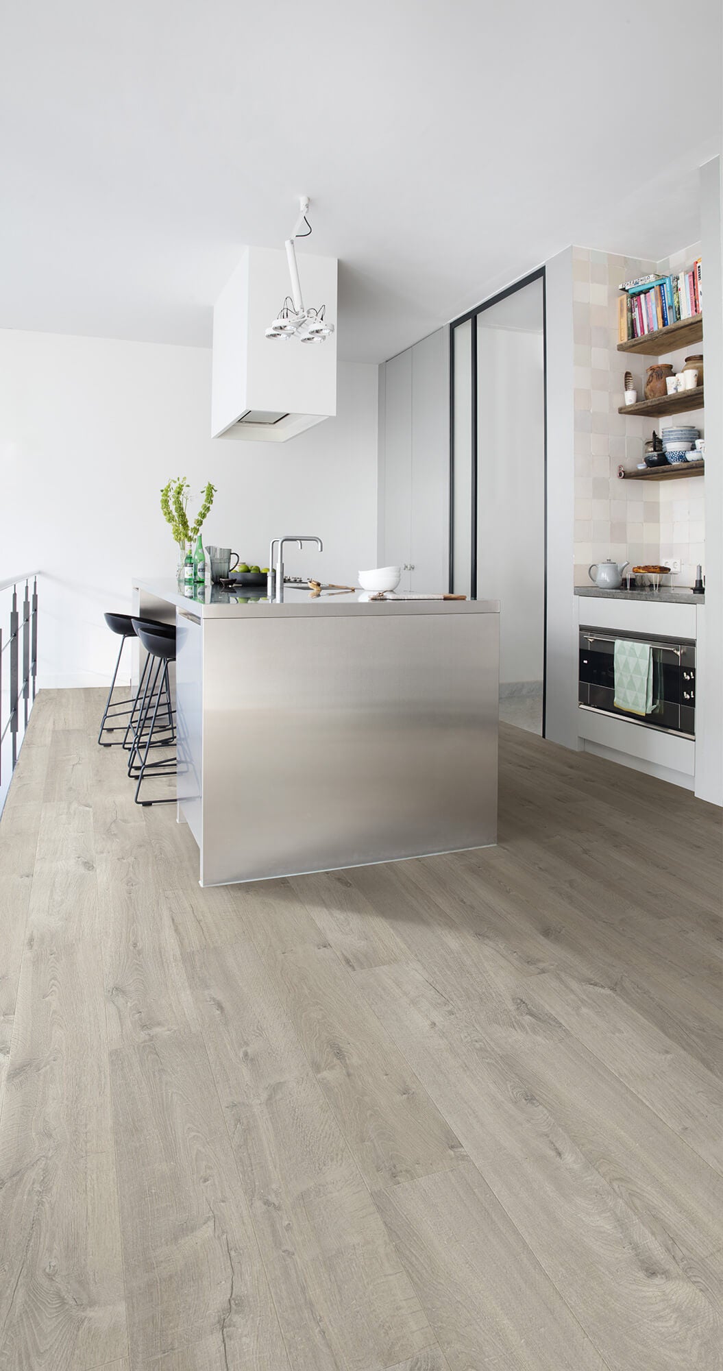 Modern kitchen with stainless steel appliances and light wood flooring