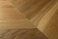 Close-up of wooden flooring with a herringbone pattern