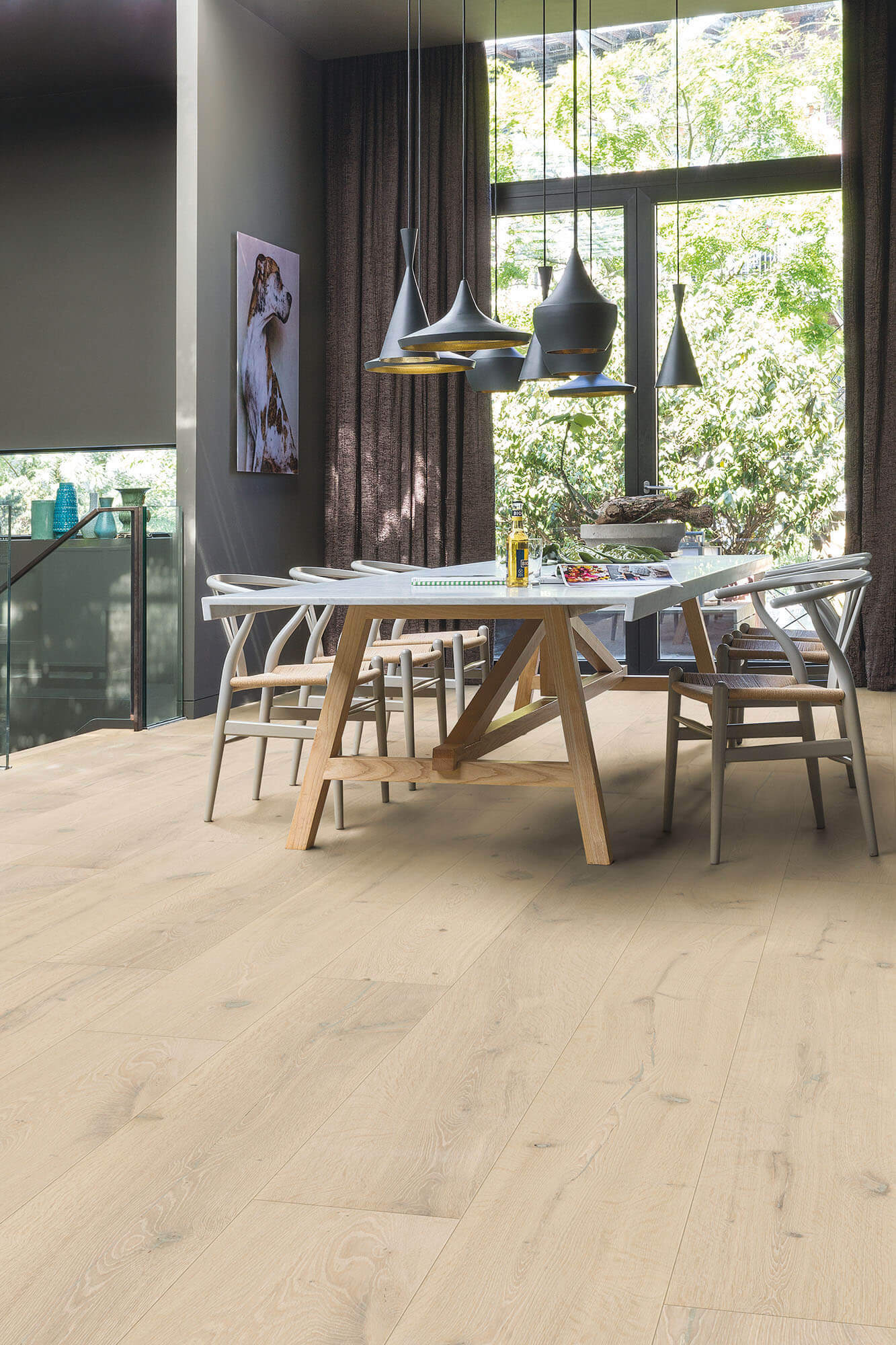 Modern dining area with wooden table and chairs on a light wood floor.