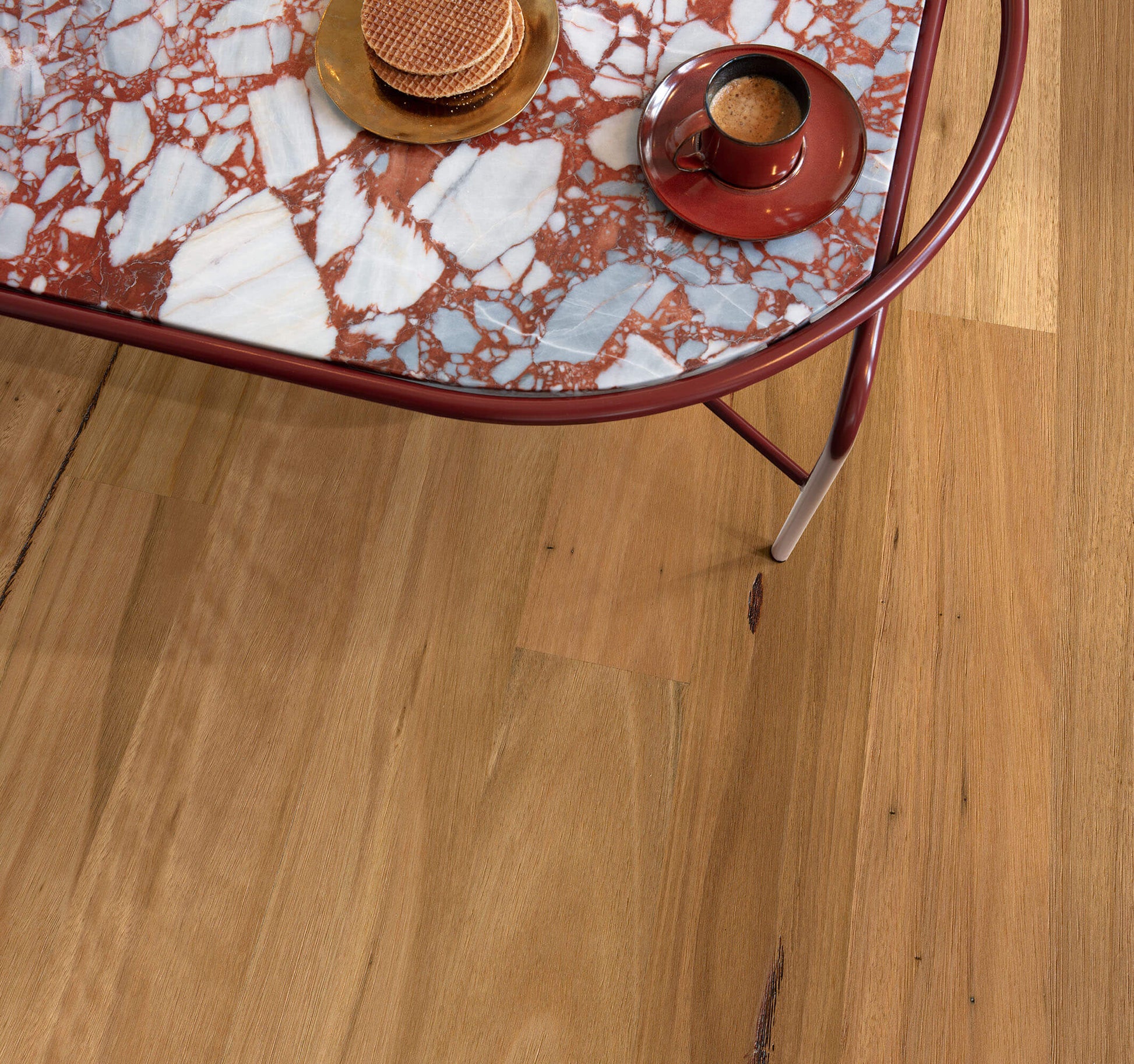 Marble-patterned table with decorative items on a wooden floor