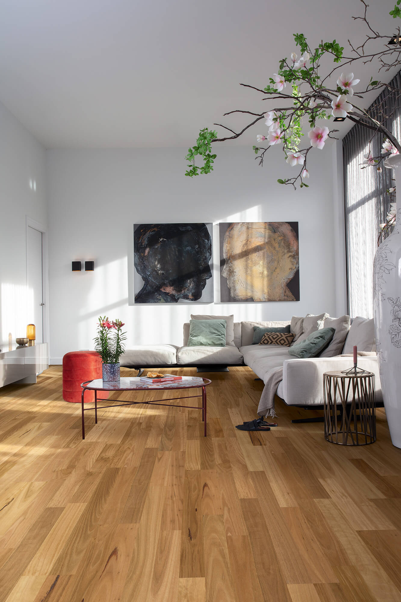 Modern living room with a chandelier, sofa, and coffee table.