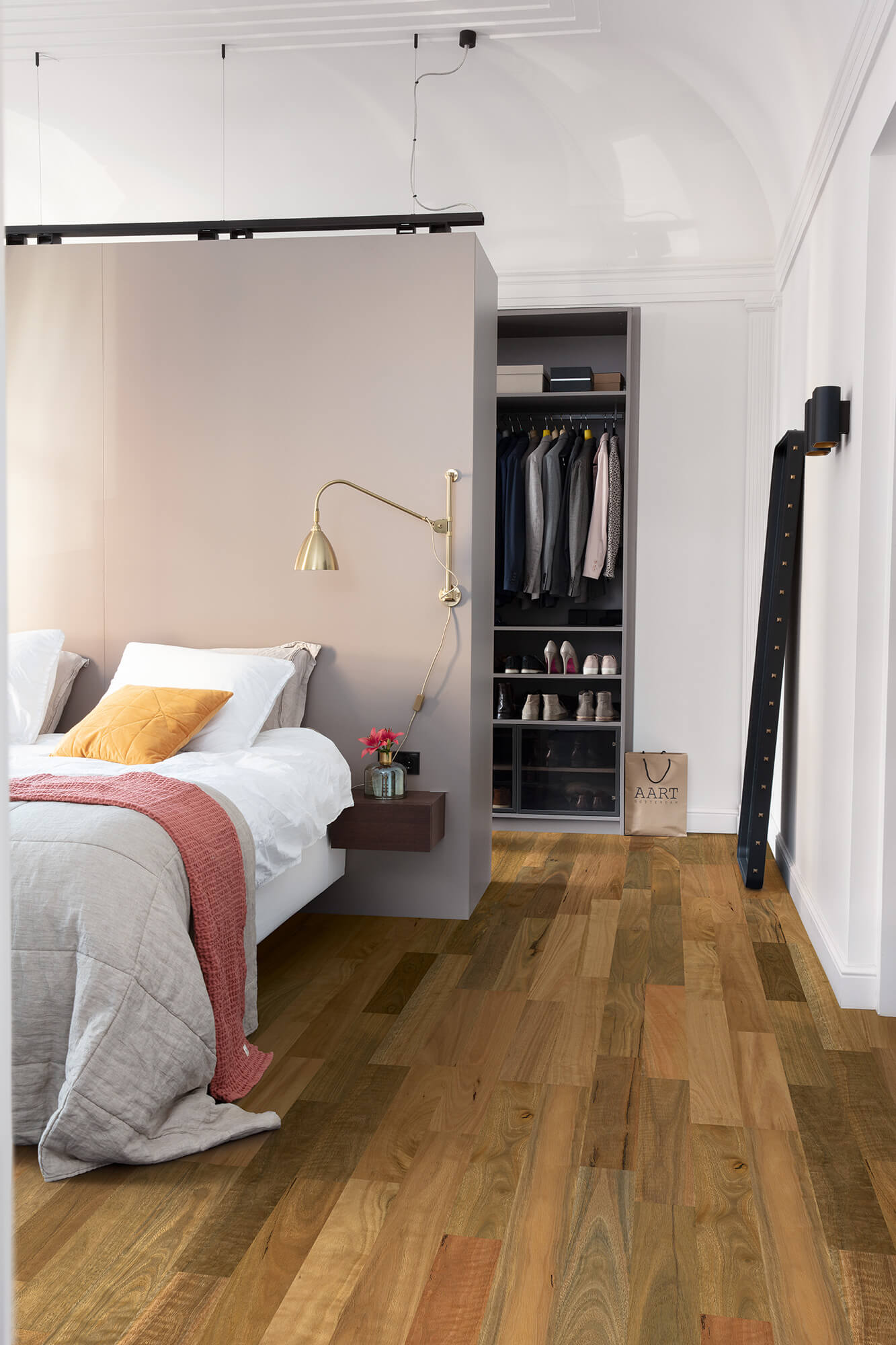 Modern bedroom with a Murphy bed, wooden floor, and closet.