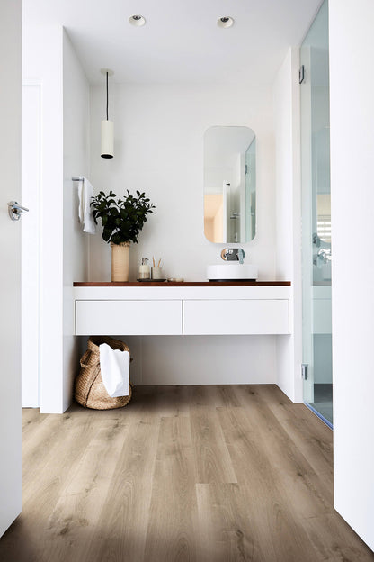 Modern bathroom with wooden vanity, mirror, and plant
